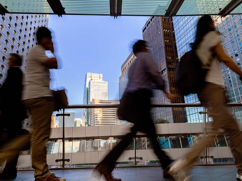 Peoples are walking in between the buildings