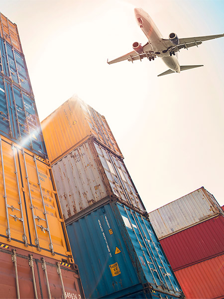 Airplane flying above cargo container