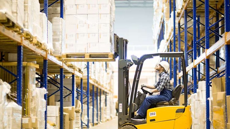Warehouse driver keeping the boxes on shelf