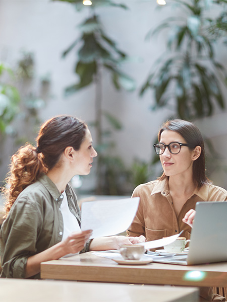 Two Young Businesswomen in Cafe