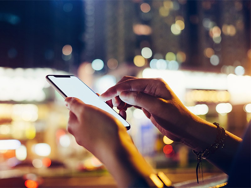 Close up of women's hand using mobile app on smartphone