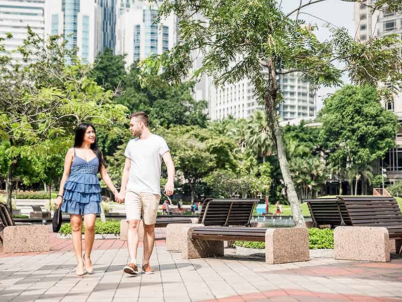 A couple is walking holding hands