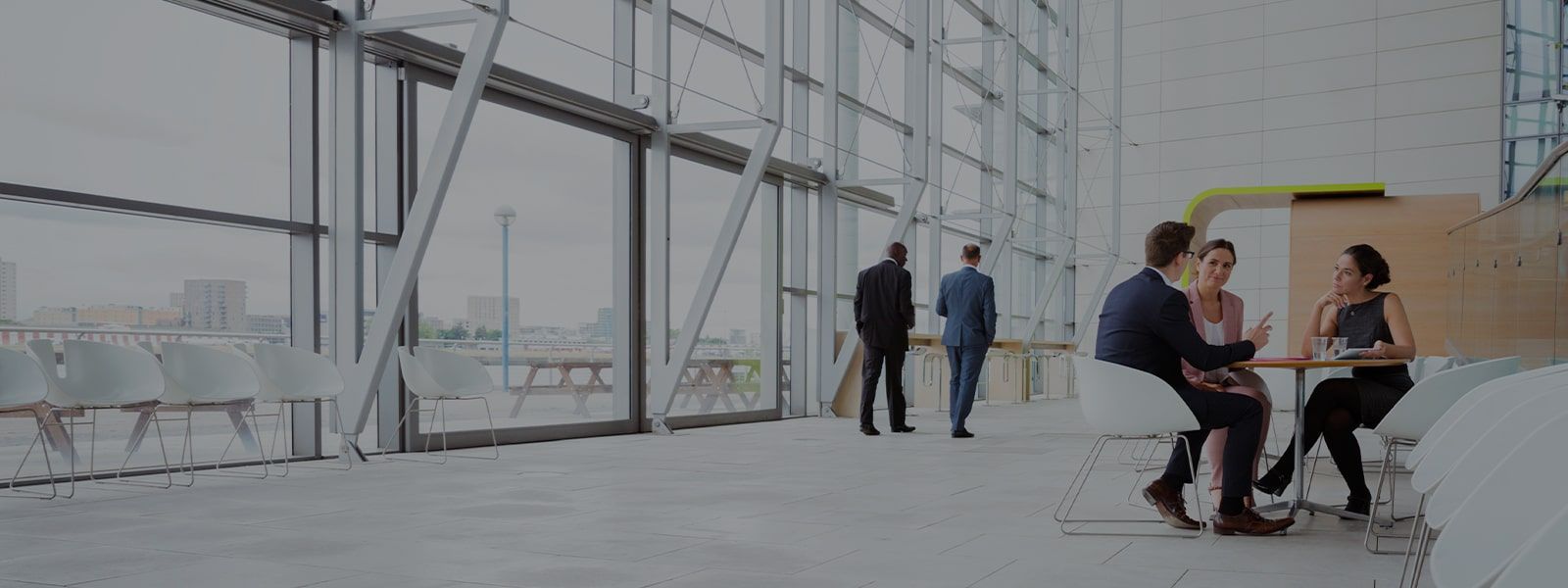 Business people discussing plans in modern lobby