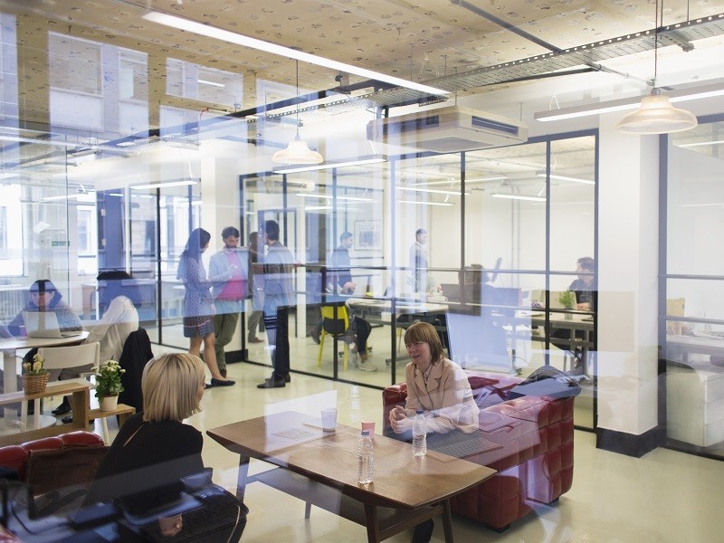 employee sitting in different areas of flexible work space