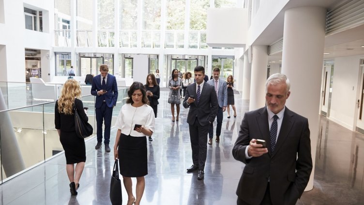 Businesspeople Using Technology In Busy Lobby Area Of Office; Shutterstock ID 479614768; Departmental Cost Code : 162800; Project Code: GBLMKT; PO Number: GBLMKT; Other: