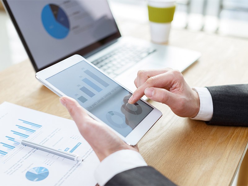 Employee checking financial reports on a tablet